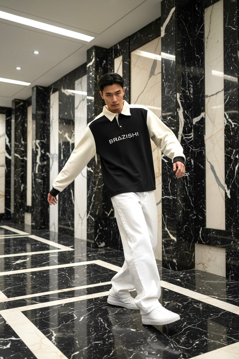 Man wearing a black and ivory outfit with BRAZISHI text in a marble hallway.